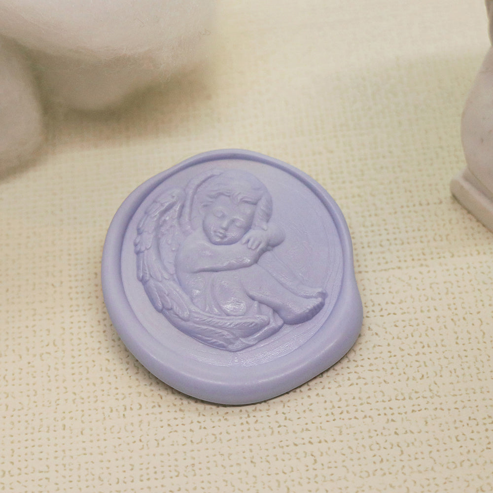 A 3D relief sleeping cherub wax stamp from AMZ Deco.